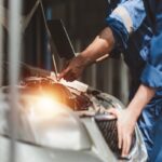 Un meccanico intento a fare la revisione di un'automobile